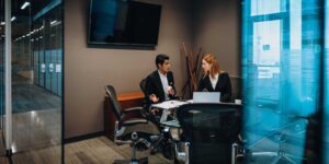 Employees sitting in conference room talking